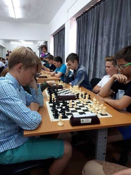 Children focused on a game of chess in the cultural centre.