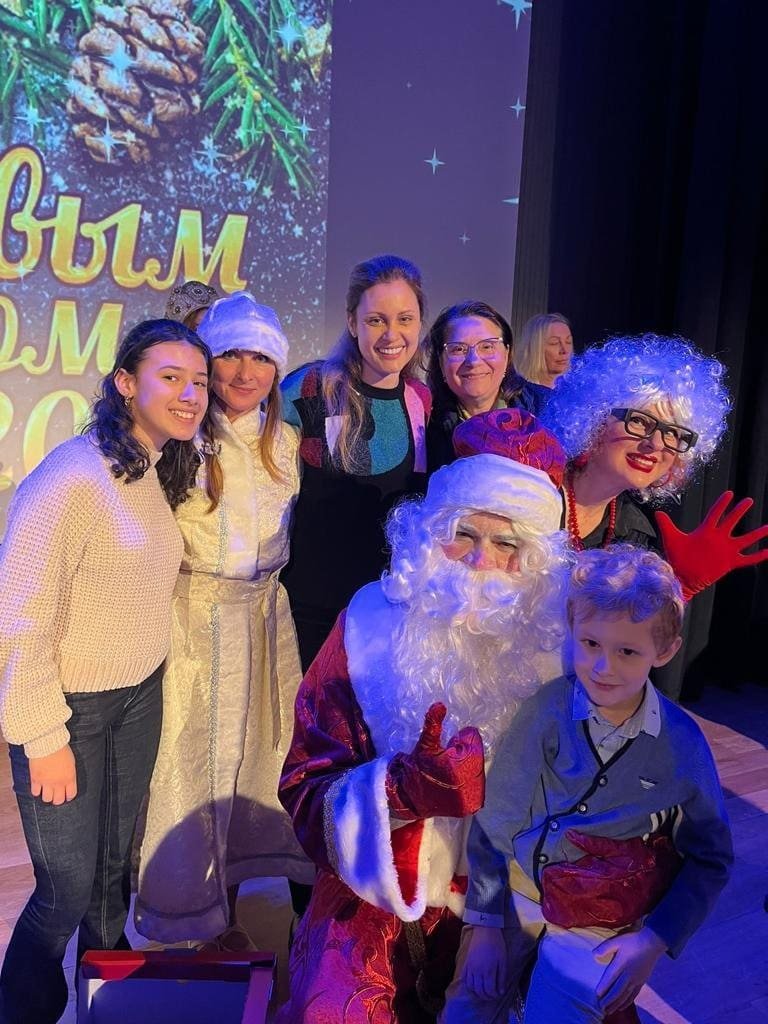 Grupo de personas con Santa Claus en evento navideño.